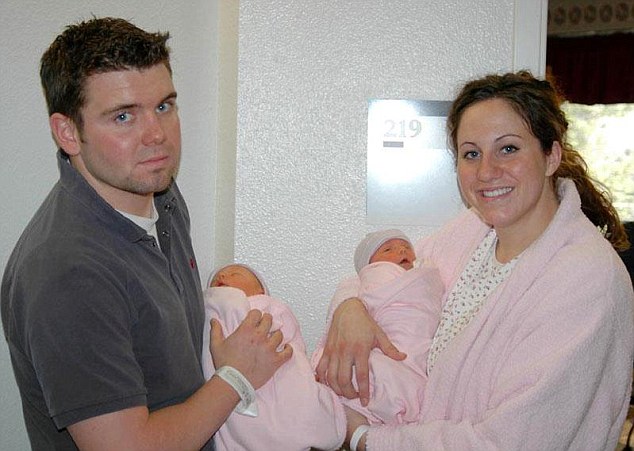 Happier times: Mrs Birk is seen here in hospital with Mr Corrigan and their twin daughters 10 years ago