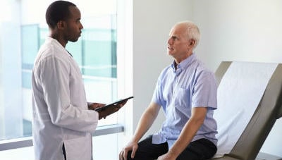 Elderly patient speaking with a doctor